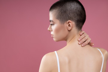 Fototapeta na wymiar Thoughtful lady touching the back of her neck stock photo
