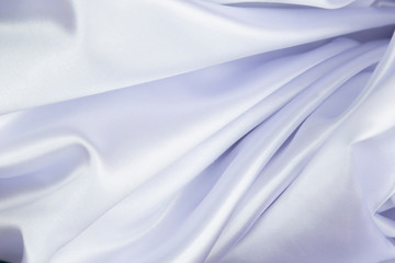 Naklejka premium White wrinkled fabric with wrinkles and waves, background and Wallpaper of crumpled tissue.