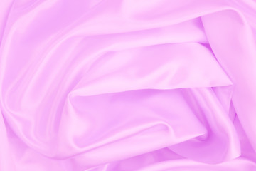 Pink wrinkled fabric with wrinkles and waves, background and Wallpaper of crumpled tissue.