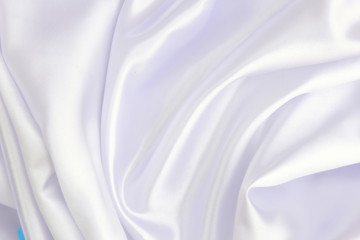 White wrinkled fabric with wrinkles and waves, background and Wallpaper of crumpled tissue.