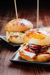 Closeup of home made burgers on wooden background