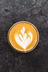 Cup of coffee on black stone background Top view