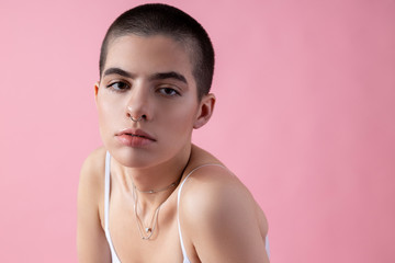 Short haired young girl putting her shoulder forward stock photo