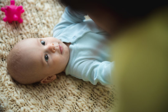 Beautiful baby looking attentively at parent stock photo
