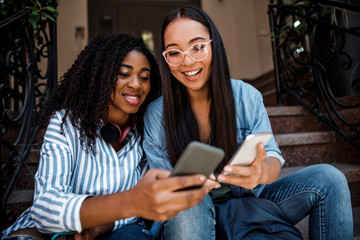 Smiling cute girls spending time together near house