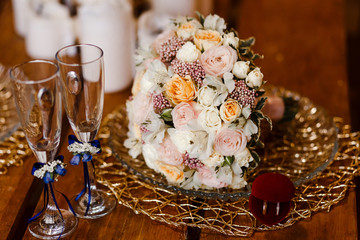 beautiful Bridal bouquet, wedding rings and champagne glasses