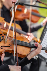 Violinists playing the violins in an orchestra. Selective focus at  © Mazur Travel