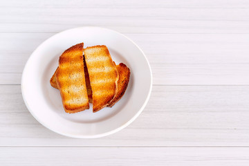 Background with slices of toast bread and wooden table.