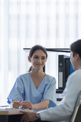 A doctor take care of sick patient woman at the hospital or medical clinic.