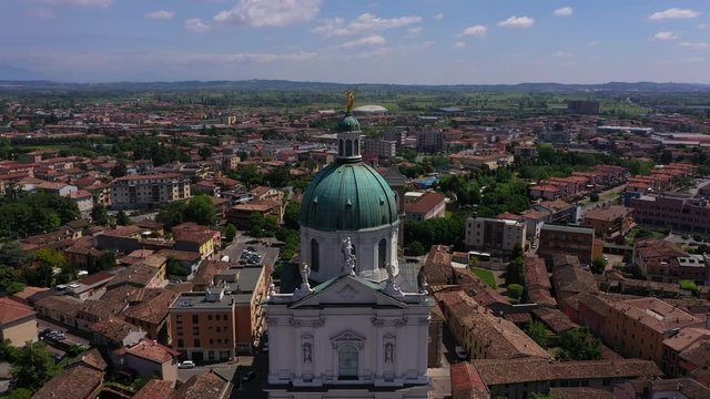 Flying over the Parish of Santa Maria Assunta, Montichiari, Italy. Blue sky. Aerial view	