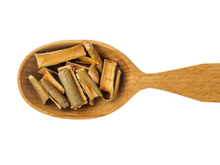 Dry willow bark in wooden spoon on white background