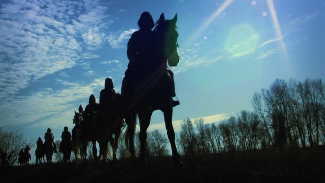 Riders ride on horseback across the steppes