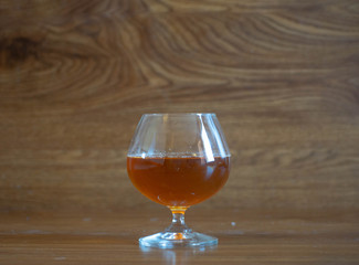 composition with glass with delicious whiskey on oak boards