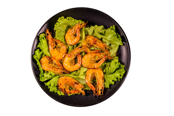 Plate with grilled shrimps and lettuce leaves isolated on a white background