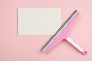 Window brush lying on empty white mockup on pink background. Concept cleaning service