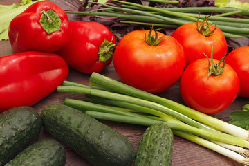 Summer vegetables and greens on a wooden table