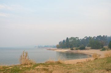 Lake Jindabyne covered in a smokey haze