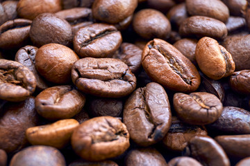 Closeup of dark brown roasted coffee beans to use as a background.