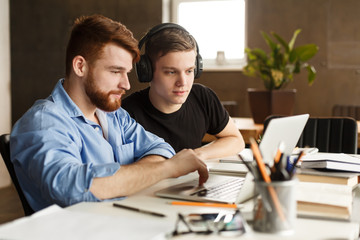 Education concept. Mates networking internet on laptop