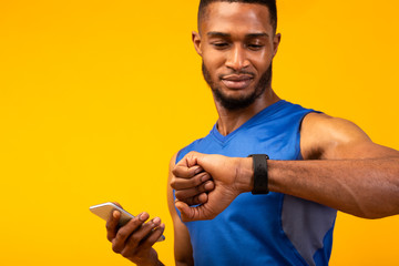 Headshot of black guy looking at watch