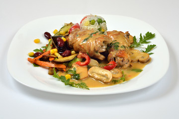 Food from a chicken restaurant with vegetables and sauce.