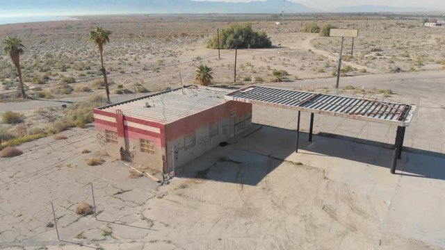 Aerial drone shot of abandoned gas station near Bombay Beach ghost town, Salton Sea California