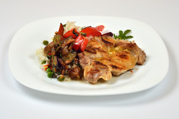 Food from a chicken restaurant with vegetables and sauce.