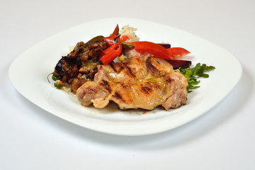 Food from a chicken restaurant with vegetables and sauce.