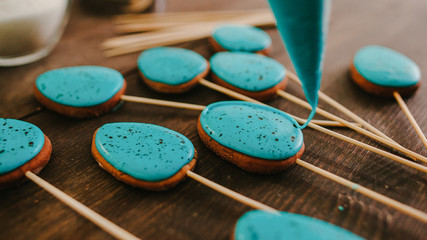 Festive culinary. Homemade Easter biscuits. Cake pops turquoise blue icing.