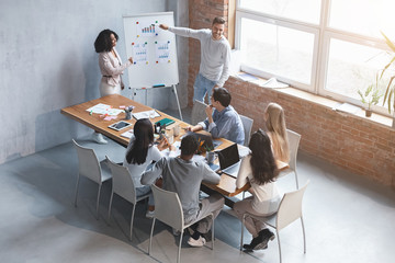 Man and woman making business presentation to colleagues in office