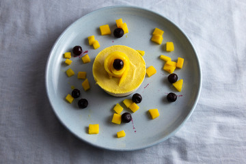 Fresh mango and mango raw cake with blueberry