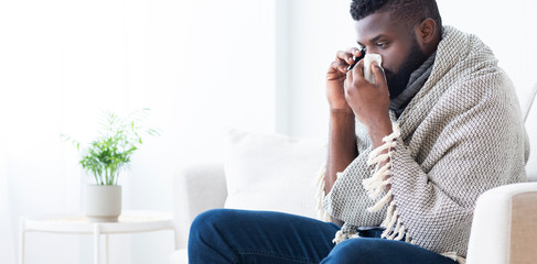 Sick african man calling to hospital for help, panorama
