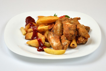 Food from a chicken restaurant with vegetables and sauce.