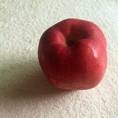 red apple on white table