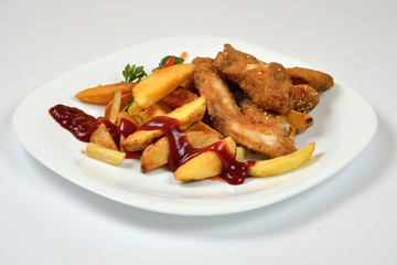 Food from a chicken restaurant with vegetables and sauce.