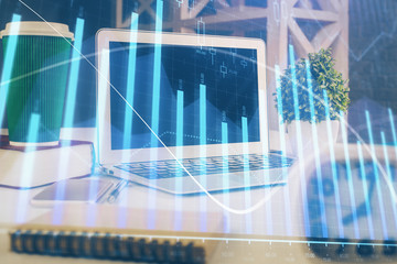 Forex Chart hologram on table with computer background. Double exposure. Concept of financial markets.