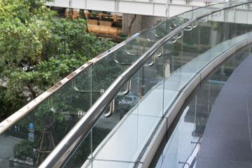 tempered glass of walk way balcony with stainless steel handrail.
