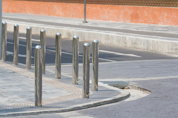 stainless steel bollards on footpath at the street corner. traffic equipment for prevent accident .