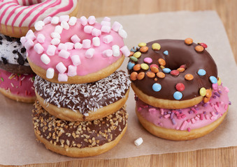 heap of colorful doughnuts on a table