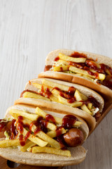 Homemade Cleveland Polish Boy Sandwich on a rustic wooden board on a white wooden surface, low angle view. Copy space.
