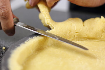 Trimming excess of dough. Making Chocolate, Pear and Pecan Pie Series.