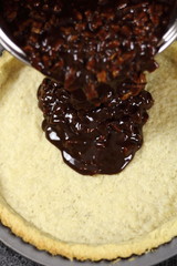 Pouring filling into pastry case. Making Chocolate, Pear and Pecan Pie Series.