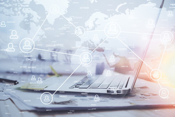 Computer on desktop with social network hologram. Multi exposure. Concept of international people connections.