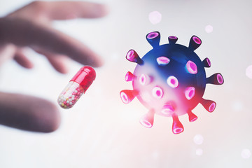 Hand holding pill and coronavirus molecule
