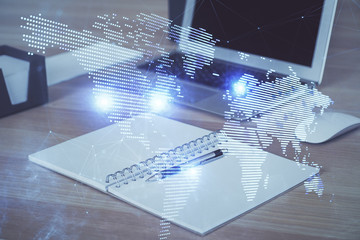 Computer on desktop with social network hologram. Multi exposure. Concept of international people connections.