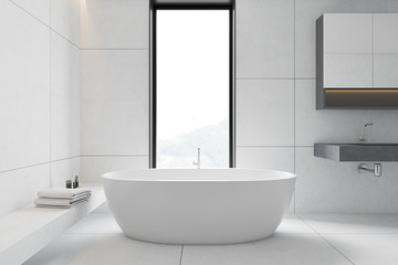 White tile bathroom interior, tub and sink