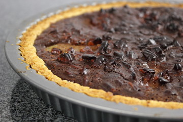 Freshly baked tart in baking tin. Making Chocolate, Pear and Pecan Pie Series.