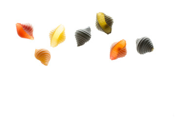 Raw multi-colored pasta on a white background