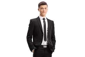 Young man in a suit posing with his hands in pocket