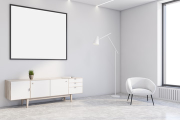 White living room corner with armchair and poster